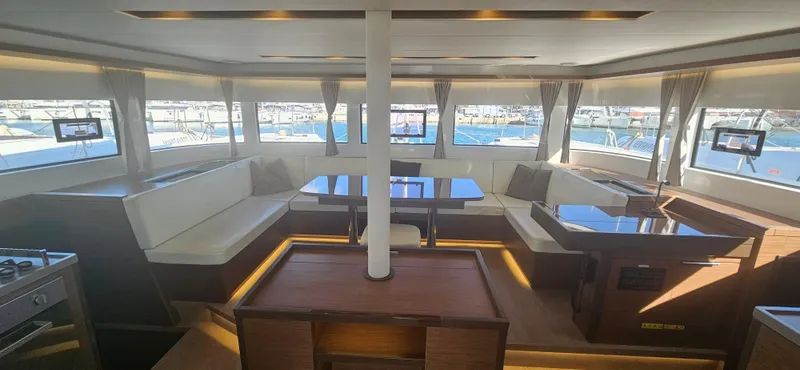  Yacht Photos Pics Luxurious interior of 2022 Lagoon 50 catamaran with spacious seating and panoramic windows.