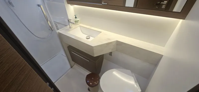  Yacht Photos Pics Modern bathroom in 2022 Lagoon 50 yacht with sleek fixtures and ambient lighting.