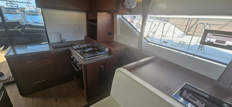  Yacht Photos Pics Interior of 2022 Lagoon 50 yacht kitchen with modern appliances and sleek design.