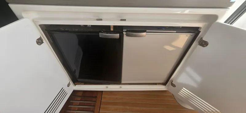  Yacht Photos Pics Open storage compartment on Lagoon 50 yacht, 2022 model, with wooden flooring.