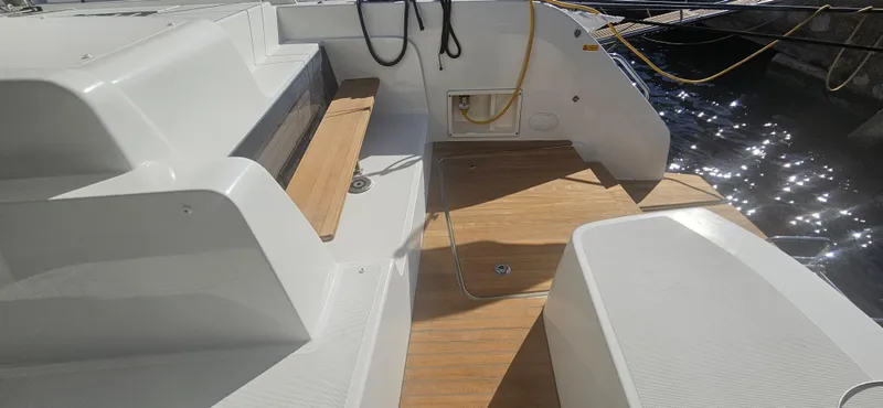  Yacht Photos Pics 2022 Lagoon 50 yacht deck with wooden flooring and seating area.