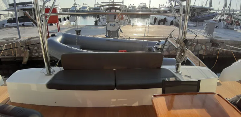  Yacht Photos Pics 2022 Lagoon 50 yacht interior with seating, docked at a marina.