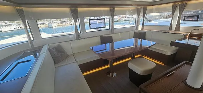  Yacht Photos Pics Luxurious interior of a 2022 Lagoon 50 yacht with elegant seating and panoramic windows.