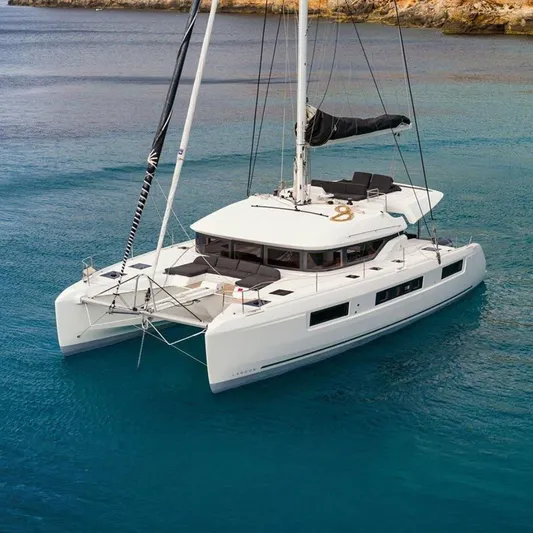 Yacht Photos Pics 2022 Lagoon 50 catamaran sailing in clear blue waters.