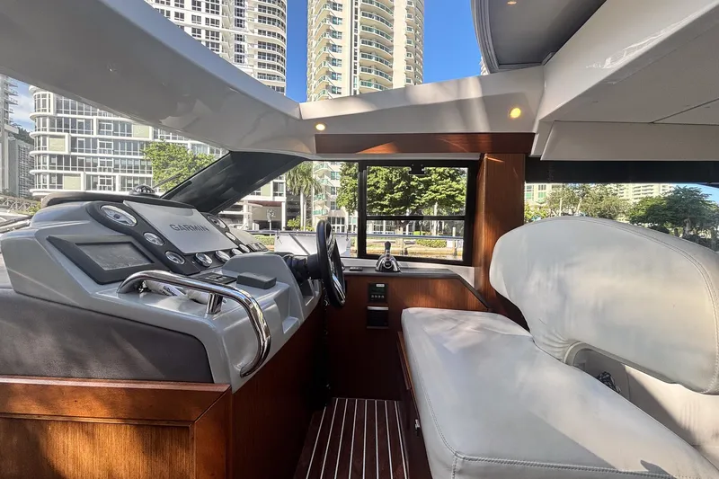 Fly-away Yacht Photos Pics Interior of 2015 Bavaria 420 Virtess Coupe yacht with modern dashboard and cityscape view.
