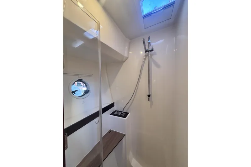Fly-away Yacht Photos Pics Shower area in 2015 Bavaria 420 Virtess Coupe yacht with porthole and skylight.