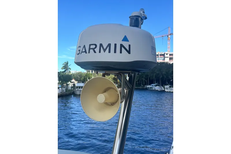Fly-away Yacht Photos Pics Garmin radar on 2015 Bavaria 420 Virtess Coupe, docked by a scenic waterfront.