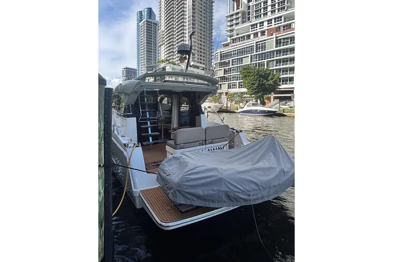 Fly-away Yacht Photos Pics 2015 Bavaria 420 Virtess Coupe docked near modern high-rise buildings.