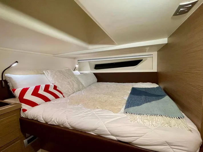  Yacht Photos Pics Cozy bedroom interior of 2023 Solaris Power SP 44 yacht with modern design and comfortable bedding.