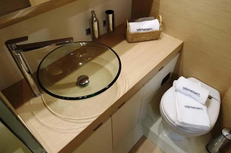  Yacht Photos Pics Luxurious bathroom in 2023 Solaris Power SP 44 yacht with modern glass sink and elegant fixtures.