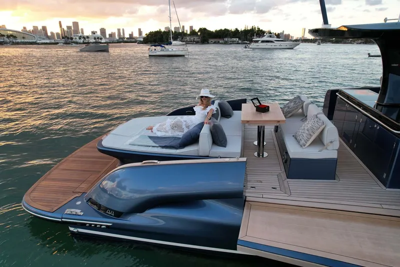  Yacht Photos Pics 2023 Solaris Power SP 44 yacht with luxurious deck, scenic waterfront view, and city skyline backdrop.