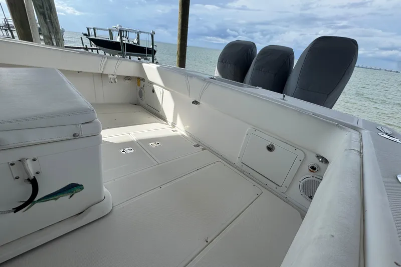  Yacht Photos Pics 2006 SeaVee 34 CC boat interior with spacious deck and covered engines, docked by the sea.