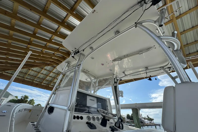  Yacht Photos Pics 2006 SeaVee 34 CC boat interior under wooden roof, featuring steering console and clear sky.