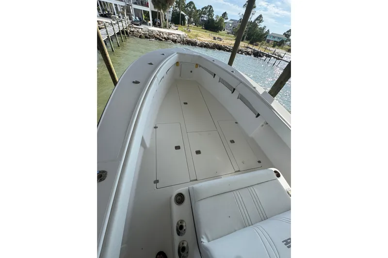  Yacht Photos Pics 2006 SeaVee 34 CC boat deck with storage compartments, docked by the water.