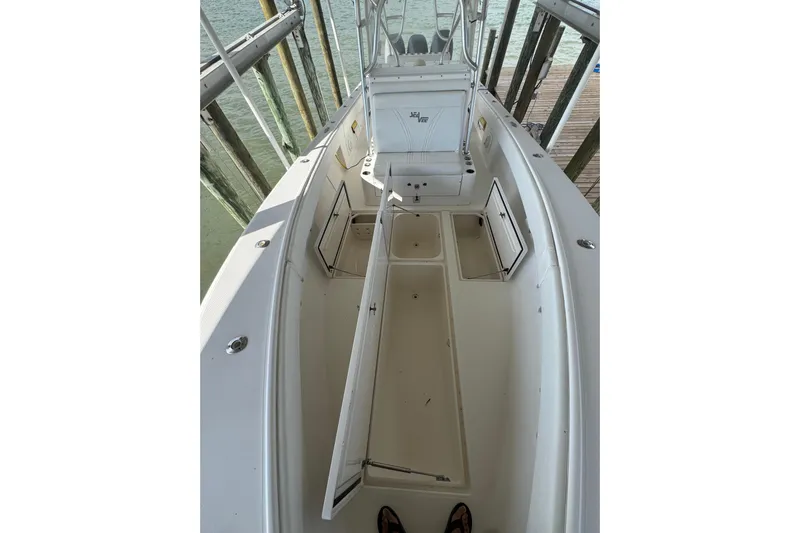  Yacht Photos Pics 2006 SeaVee 34 CC boat interior with open storage compartments, docked by the water.