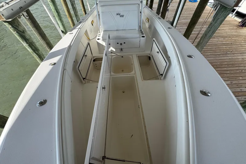  Yacht Photos Pics 2006 SeaVee 34 CC boat interior with open storage compartments, docked by wooden posts.