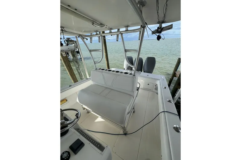  Yacht Photos Pics 2006 SeaVee 34 CC boat interior with seating and steering wheel, docked by the water.