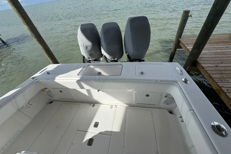  Yacht Photos Pics 2006 SeaVee 34 CC boat with covered engines docked by the water.