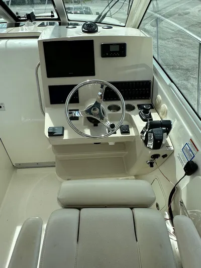  Yacht Photos Pics 2019 Boston Whaler 345 Conquest helm with steering wheel, controls, and navigation equipment.