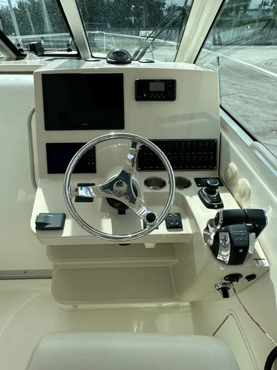  Yacht Photos Pics 2019 Boston Whaler 345 Conquest helm with steering wheel and control panel.