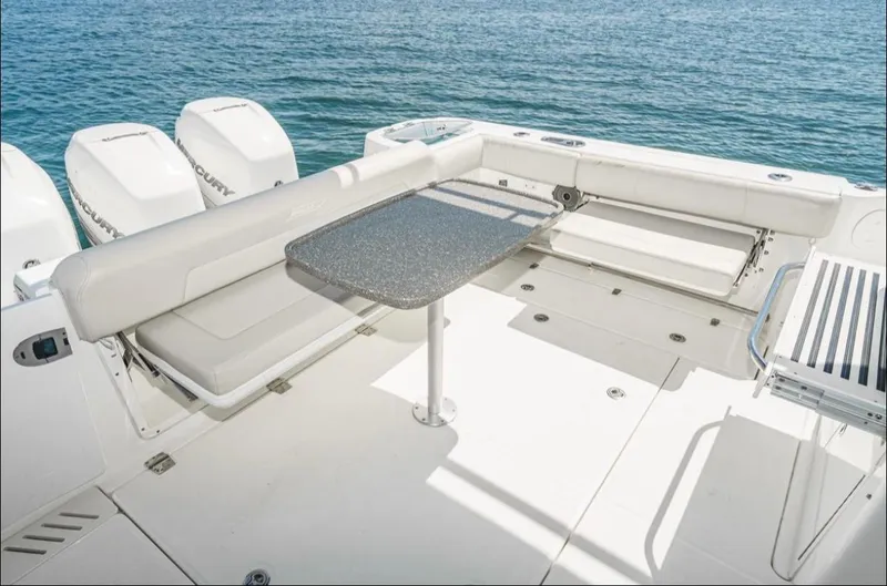  Yacht Photos Pics 2019 Boston Whaler 345 Conquest boat deck with seating and table, overlooking the ocean.