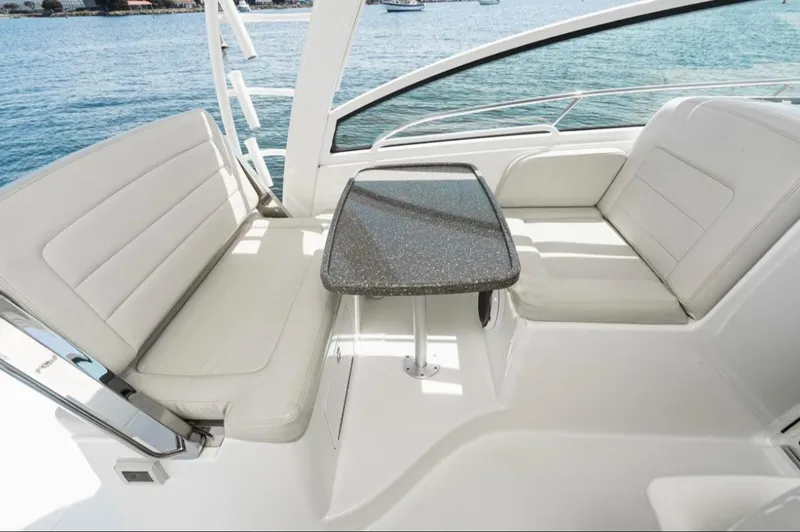  Yacht Photos Pics 2019 Boston Whaler 345 Conquest interior with cushioned seating and table, overlooking the ocean.