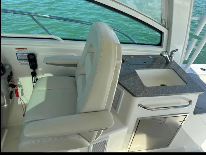  Yacht Photos Pics 2019 Boston Whaler 345 Conquest interior with seat and sink, overlooking water.