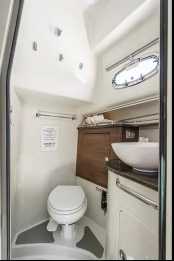  Yacht Photos Pics 2019 Boston Whaler 345 Conquest bathroom with modern fixtures and compact design.