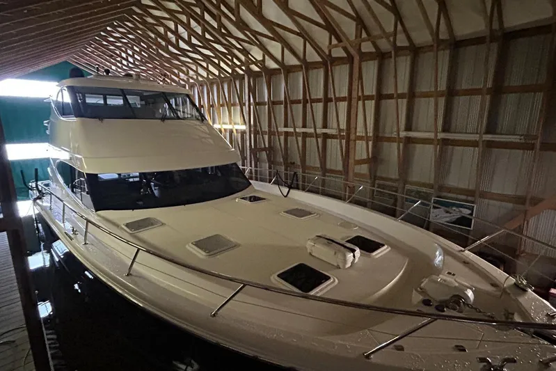  Yacht Photos Pics 2020 Maritimo M64 yacht docked in a wooden boathouse.
