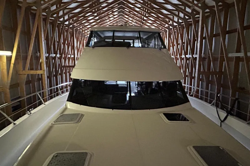  Yacht Photos Pics 2020 Maritimo M64 yacht docked in a wooden boathouse.