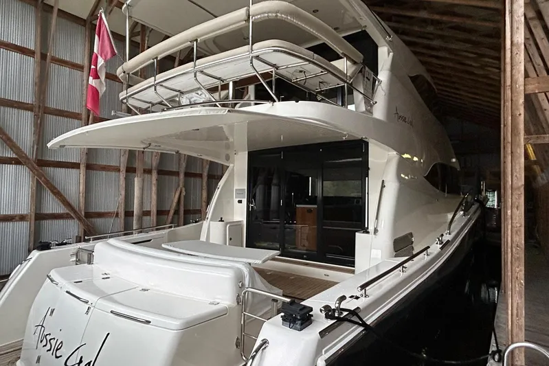  Yacht Photos Pics 2020 Maritimo M64 yacht docked in a wooden boathouse, rear view.