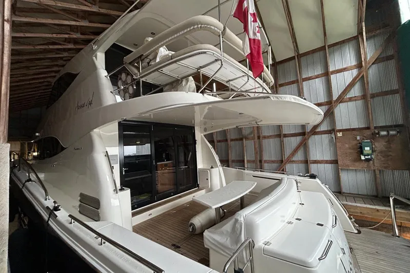  Yacht Photos Pics 2020 Maritimo M64 yacht docked indoors with Canadian flag displayed.