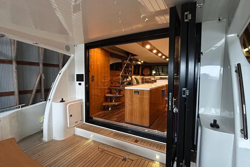  Yacht Photos Pics Luxurious interior of 2020 Maritimo M64 yacht with modern kitchen and wooden accents.