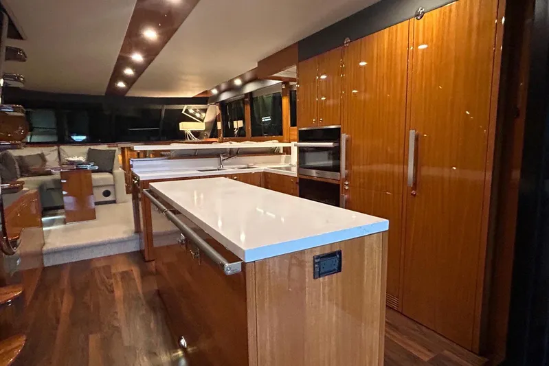  Yacht Photos Pics Luxurious interior of 2020 Maritimo M64 yacht with modern kitchen and seating area.