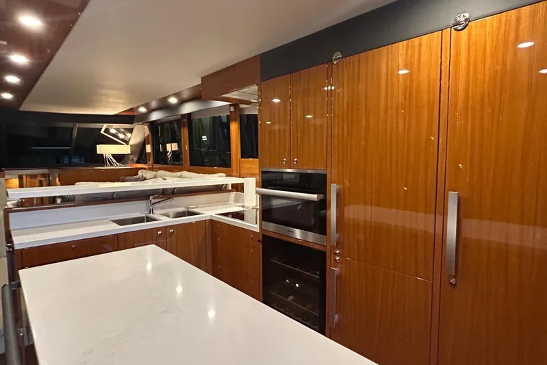  Yacht Photos Pics Luxurious kitchen interior of 2020 Maritimo M64 yacht with sleek wood cabinetry and modern appliances.