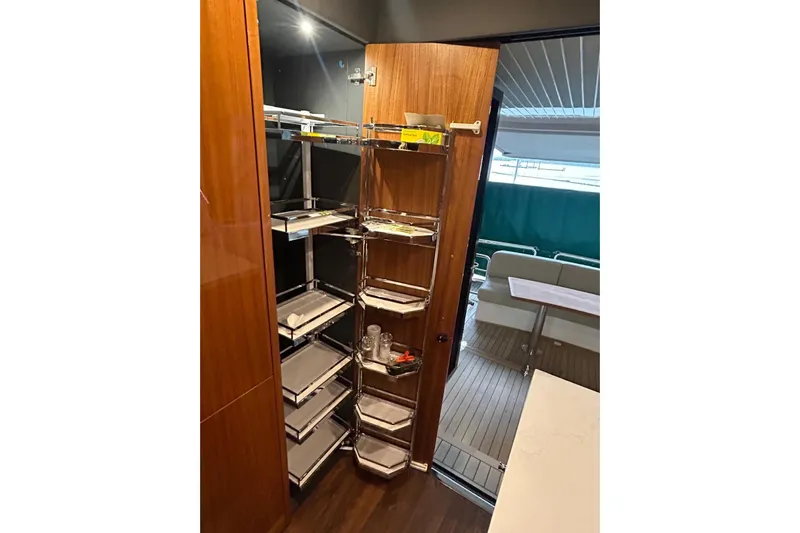  Yacht Photos Pics Interior of 2020 Maritimo M64 yacht with open pantry and outdoor seating area.