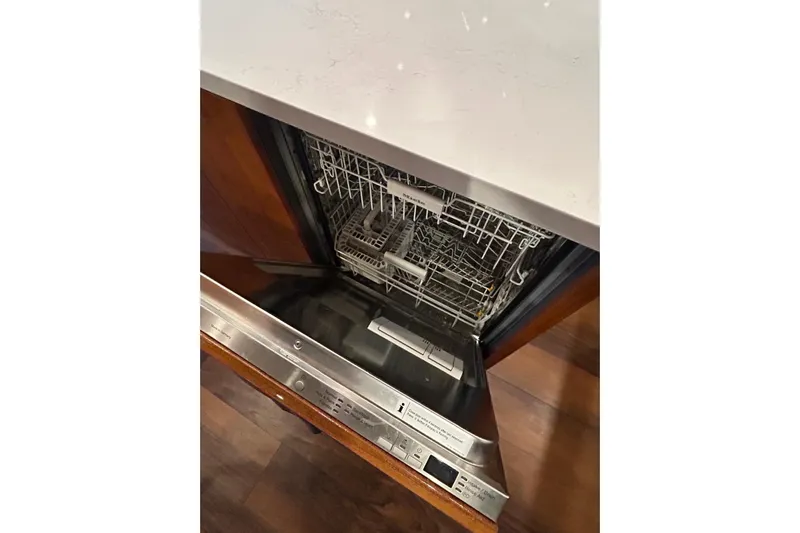  Yacht Photos Pics Open dishwasher in a Maritimo M64 yacht, 2020 model, with wooden flooring.