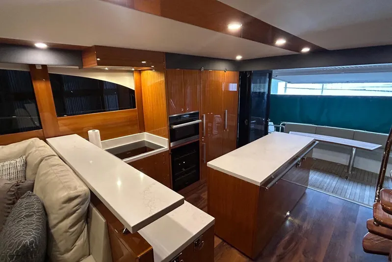  Yacht Photos Pics Luxurious interior of 2020 Maritimo M64 yacht with modern kitchen and seating area.