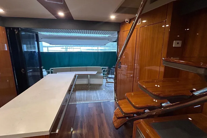  Yacht Photos Pics Luxurious interior of 2020 Maritimo M64 yacht with wooden finishes and modern seating area.