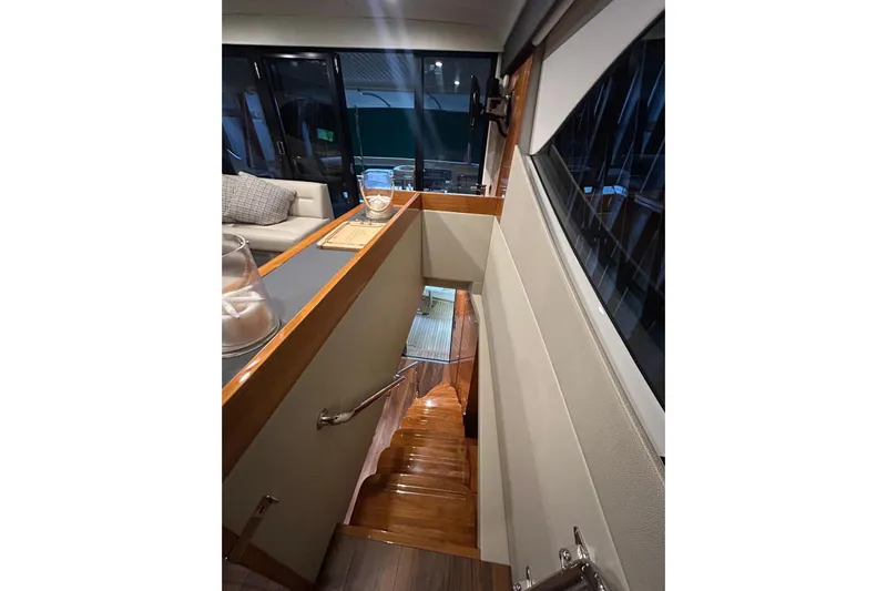  Yacht Photos Pics Interior view of 2020 Maritimo M64 yacht, featuring elegant wooden stairs and modern design.