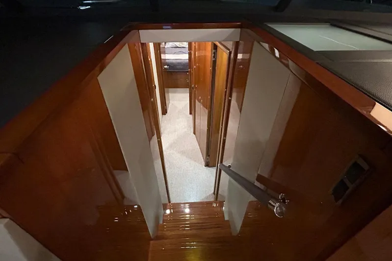  Yacht Photos Pics Interior view of 2020 Maritimo M64 yacht, featuring polished wood finishes and hallway.