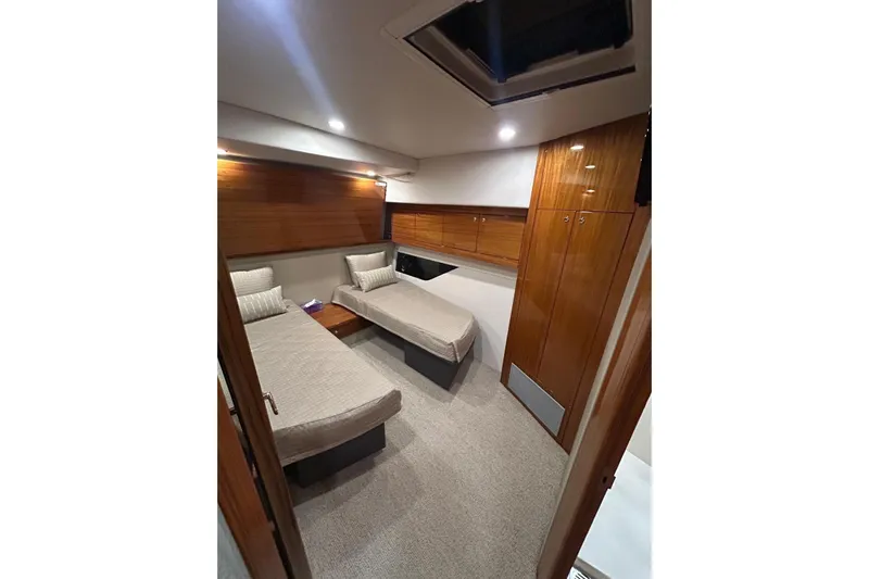  Yacht Photos Pics Luxurious cabin interior of 2020 Maritimo M64 yacht with twin beds and wooden finishes.