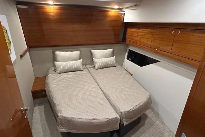  Yacht Photos Pics 2020 Maritimo M64 yacht cabin with twin beds and wooden cabinetry.