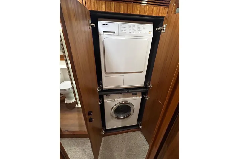  Yacht Photos Pics Stacked washer and dryer in 2020 Maritimo M64 yacht's wooden cabinet.