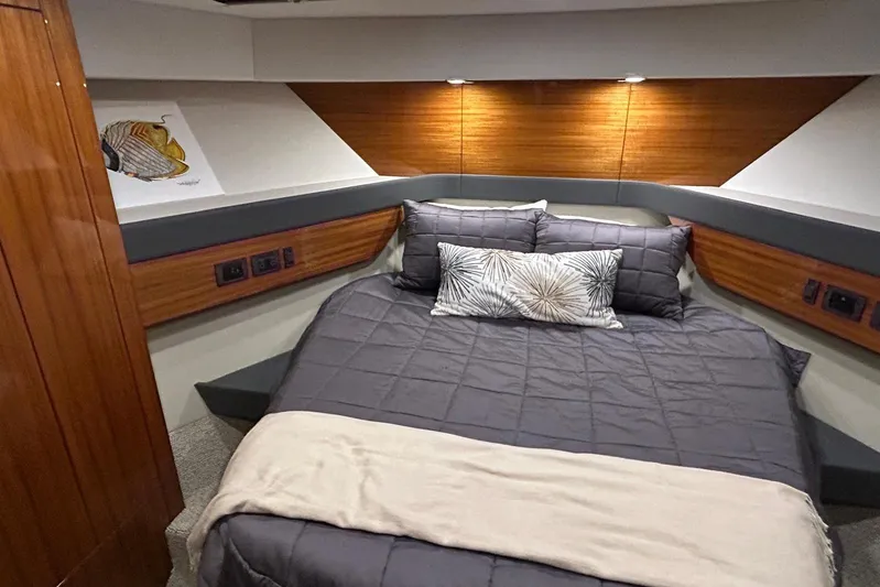  Yacht Photos Pics Luxurious cabin interior of 2020 Maritimo M64 yacht with cozy bedding and elegant wood accents.