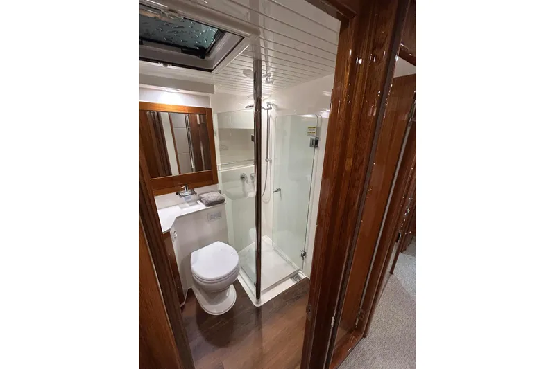  Yacht Photos Pics Luxurious bathroom in 2020 Maritimo M64 yacht with glass shower and wooden accents.