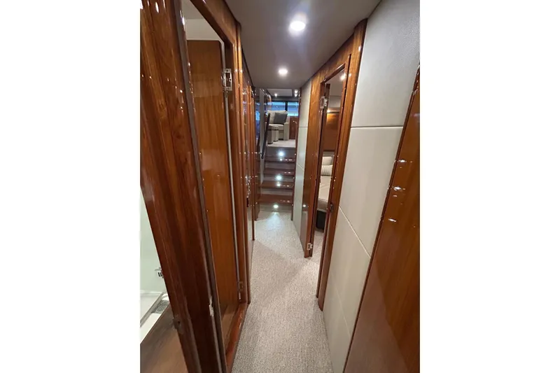  Yacht Photos Pics Luxurious interior hallway of 2020 Maritimo M64 yacht with polished wood finishes.