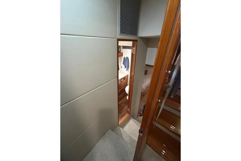  Yacht Photos Pics Interior view of 2020 Maritimo M64 yacht, featuring a narrow hallway and wooden finishes.