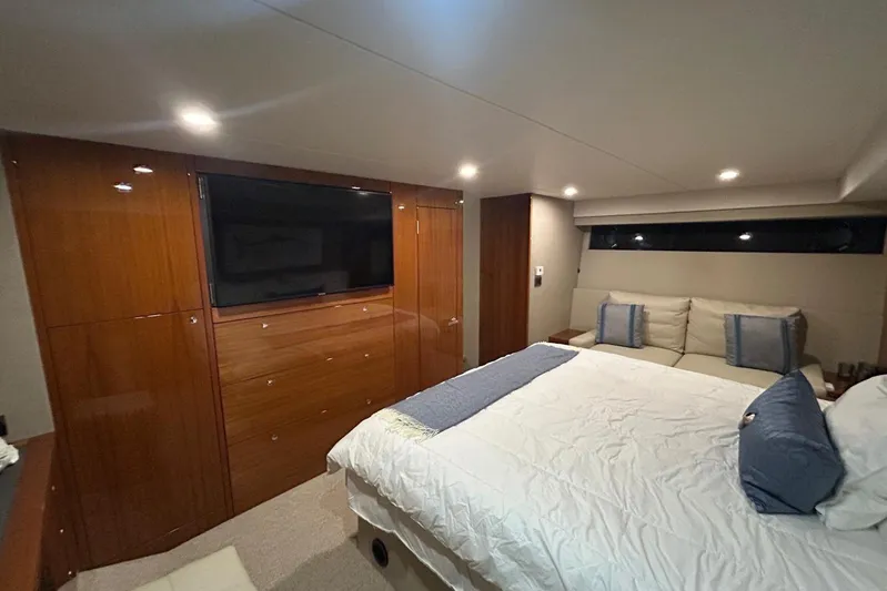 Yacht Photos Pics Luxurious 2020 Maritimo M64 yacht bedroom with elegant wood paneling and modern furnishings.