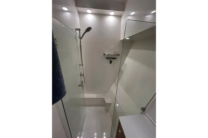  Yacht Photos Pics Modern shower area in 2020 Maritimo M64 yacht, featuring sleek design and lighting.
